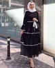 Robes décontractées femmes musulmanes jupe évasée forme de gâteau à manches longues Robe en couches prière islamique Jibab volant solide robe de mode arabe