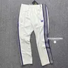 Pantalones para hombres Estilo Púrpura Raya Agujas Sweetpants Hombres Mujeres Blanco Bordado Mariposa Awge Cordón Pista 231201