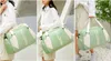 Kvinnors väskor stor kapacitet färsk trend kvinnors väskor multifunktionella slitsträckta damer resväska kan hänga vagnsäckar