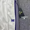 Calças masculinas estilo roxo listra agulhas sweatpants homens mulheres branco bordado borboleta awge cordão pista 231201