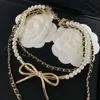 24SS Designer Channel Xiangjia 23 Summer New Pearl Chain Stacked Wearing Wind Leather Wearing Long Multi Layered Bow Small Xiangfeng Brass Necklace