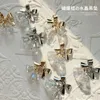 Nagelkonstdekorationer 50st Gold Silver Alloy Bell Christmas Butterfly Bow Ribbon Rheinestone Shiny Year's Nail Charms DIY Nail Art Decoration 231202