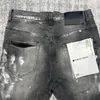بنطلون جينز للرجال 23SS الموضة الصيفية الأرجواني العلامة التجارية عالية الجودة غسلها سراويل قديمة ممزق