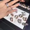 Diseñador de moda de lujo Fiesta de joyería Alta calidad Diamante completo Estrella del cielo Anillo de tres filas Clásico Tendencia versátil Hombres y mujeres Par eterno