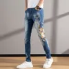 Outono e inverno jeans marca de moda masculina moda nacional kirin bordado calças masculinas elástico fino ajuste pés calças china-chique