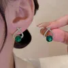 Boucles d'oreilles pendantes U-Magical Fantasy, strass violets et verts pour femmes, bijoux de fête en métal creux avec croix scintillante