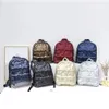 Sacos de noite mulheres mochilas casuais para baixo carta impressão mochila outono inverno estilo coreano moda espaço algodão cor sólida saco de escola 231207