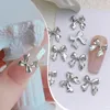 Décorations d'art d'ongle 1 sac 3D argent or en forme de nœud papillon breloques en alliage de métal coeur Nail Art strass manucure bijoux pour bricolage accessoires d'ongles 231207