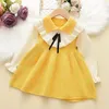 Flickaklänningar Girls 'Autumn Winter Dress Children's Sweater Korean version Fake Two-Piece Color Matching Cute Doll Top Bow Style Style