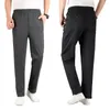 Pantalons pour hommes Hommes Respirant Sports Gym Poches lâches Entraînement Élasticité Taille Legging Jogging Pantalon de course Pantalon de survêtement de couleur unie