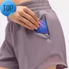 L-091 Short taille basse chaud respirant Yoga à séchage rapide Short de sport doublé intégré Fermeture éclair cachée Poches latérales encastrées Pantalon de survêtement de course avec Cont