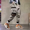 Pantaloni da uomo joggers pantaloni cargo per uomini casual hip hop hip hip tasches pantaloni per i nastri streetwear ribbons techwear pantsl231222