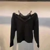 女性用セーターデザイナーライトラグジュアリーVネックレースサスペンダーツイストパターンブラックセーターデザインとニットセーターを感じる