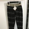 Pantaloni leggings con fettuccia a lettera Pantaloni neri alla moda da donna Pantaloni legging quotidiani da donna casual