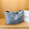 豪華なデザイナーブランドのショッピングバッグ女性のトライアングルラベル防水レジャー旅行バッグ大容量ナイロンママトート292g