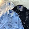 Camicette da donna camicia giapponese camicia di nicchia di nicchia cartone animato stampare a maniche lunghe Top 2023 autunno oversize unisex show blusa bianca