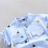 Conjuntos de roupas 2 PCS Infantil e Criança Verão Moda Corpo Inteiro Desenhos Animados Peito Pequeno Padrão Penetrante Impressão Aleatória Bolso Camisa Shorts Conjunto R231215