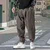 Spodnie męskie swobodne spodnie hip -hop luźne styl High Street Pasek na zewnątrz sport sporty jogging moda Harlan gorset kostka anime gym 231216