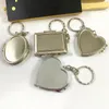 Espejo de maquillaje portátil, espejo plegable, llavero de espejo de maquillaje, llavero de Metal de doble cara, corazón redondo, juguete plegable para niñas