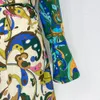 Australische designerjurk, lange linnen jurk in vakantiestijl, kleurblokkerende print, uitlopende mouwen met striksluiting in de taille