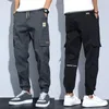 Pantaloni da uomo Tasche laterali da uomo Cargo Harem Nastri Pantaloni da jogging maschili casual Hip Hop neri Moda Streetwear 231218