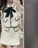 Vestido de dos piezas UNXX 2023 Estilo de primavera y otoño Pequeña fragancia Traje de moda Falda Sweet Bow Tie Jacket Conjunto de dos piezas