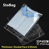 Stobag 100st 30 40 cm transparent självhäftande plast OPP -återförslutningsbara polycellofankläder KLÄNNING PACKING Presentpåse Y1202257Z