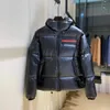 Luxus Herren Kapuzenjacke Mantel Designer Metall Dreieck Buchstaben Kleidung Puffer Baumwolle Daunenparkas für Männer Frauen Schwarze Jacken Tops Windjacke Outwears Warme Mäntel