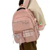 スクールバッグは、女の子の生徒のためのペンダントトラベルバッグの汎用バックパックを添えたダブルストラップショルダーナイロンブック