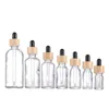 Bouteille d'huile essentielle en verre essentiel avec couvercles de bambou pipette d'emballage cosmétique transparent boute