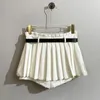 Saias 2023 Projeto de calça de primavera/verão Design da faixa versátil A-linha A-linha plissada de meia saia Mulheres