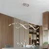 Lustres de luxe salle à manger lustre lustre moderne artistique longue table conception minimaliste avec des lignes épurées et des luminaires d'éclairage de bar