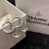 Designer Viviene Westwoods Viviennewestwood Vivienne l'impératrice douairière de l'Ouest boucles d'oreilles Saturne tridimensionnelles conception de niche féminine boucles d'oreilles haut de gamme