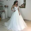 Eleganckie koronkowe aplikacje Długie rękawy suknie ślubne suknie balowe patrz przez białą tiulową sukienkę ślubną vestidos de novias