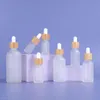 Heißverkauf tragbare Bambusdeckel Clear 5-100 ml Flasche leere Glas-Tropfen-Flaschen für ätherische Öle Make-up Öl NDFQA