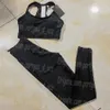 Mulheres de manga longa pretas Tretas de tilhas de luxo projetadas com tanques de ioga cortados perneiras Sexy Sporty Sporty Sportswear Tracksuit