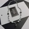2024 DESIGNERS Light luxury minority Black Pendant pearl titanium steel necklace men's and women's fashion hip-hop versatile sweater chain jewelry