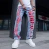 Sprucken stretchbar lighing jeans fashionabla streetwear hål rippade lapptäcke denim byxor smala magra byxor för män