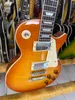 Standard electric guitar, orange honey gradient, bright light, silver accessories and tuner, available in lightning pack