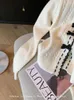 Cardigan tricoté français élégant pour femme, doux, surdimensionné, chic, col en V, manches longues, nœud, pull confortable, mode années 2000