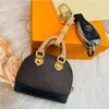 Paris Designer Porte-clés Mini Portefeuilles Porte-monnaie en cuir Marque Bagages Pendentif Porte-clés de voiture Porte-clés pour charme Hommes Femmes Top portable Sac de rangement pour écouteurs