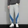 Mäns byxor Spring och Autumn Fashion Color Blocking Casual Sports Loose Drawstring Elastic Midje Sweatpants med fickor