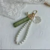 Designer porte-clés porte-clés de luxe breloque pour sac femme porte-clés de voiture perle breloque ruban vert coquillages délicats porte-clés couple pendentif cadeau sympa bon