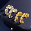 Nouvelles boucles d'oreilles de luxe conçues avec zircon incrusté de diamants en métal lisse X caractère croisé sur les femmes en forme de C de diamants complets bijoux de clous d'oreille