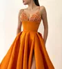 Modische orangefarbene Pailletten-Abschlussballkleider, Spaghetti-Abendkleider, Oberschenkelschlitz, formeller roter Teppich, langes Partykleid für besondere Anlässe