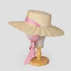 Breda randen hattar omea sommarstrån hatt fransk romantisk fluga Vete damens mode rosa band solstrand kvinnor sombrero