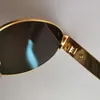 ゴールドメタル楕円形のサングラス