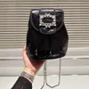 2023 High Quality Crystal Cowhide Black Women's Cowhide Backpack Small Capacity Metal Shoulder Strap Flip Pull Cord Opening Classic Casual Designer Fashion Brand