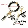 Nyckelringar Ups Party Favor Sile Cursive Cow Bead Armband Wood Disk Nyckelring Tofs Oxehuvud Handledsring Charm Hänge Drop Delivery Jew Dhzm6