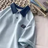 Polo da uomo Polo estiva in cotone a maniche corte Colletto con risvolto Bottoni Lettera T-shirt Coppia casual allentata Top Tees T-shirt